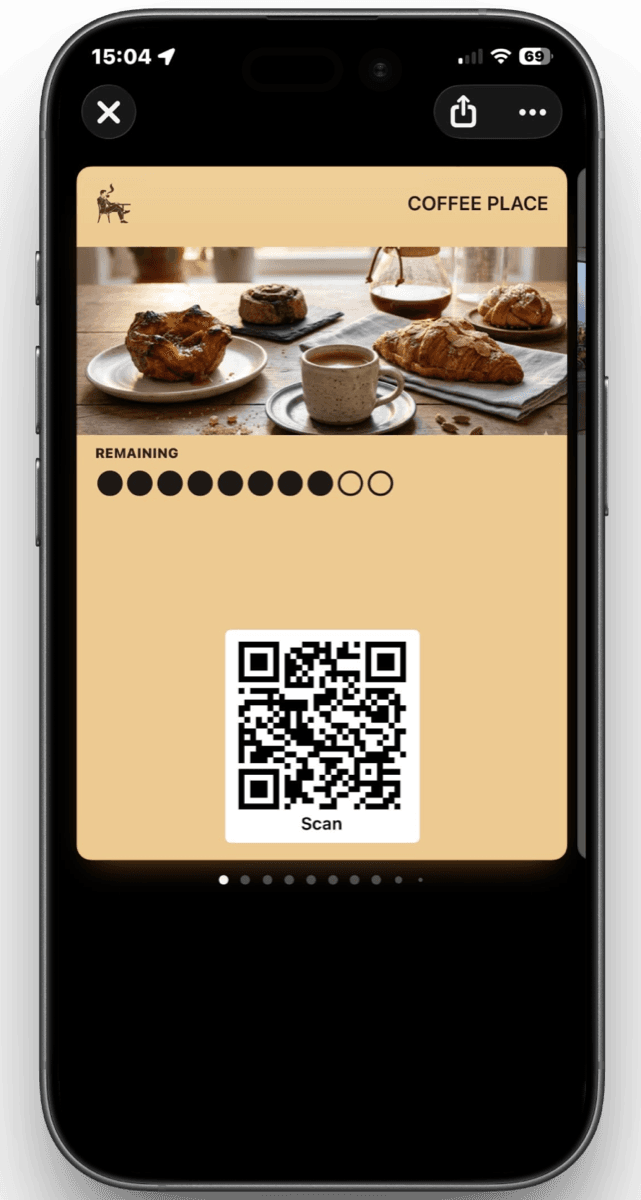 A prepaid coffee card in Apple Wallet showing coffees remaining, with a scan QR code